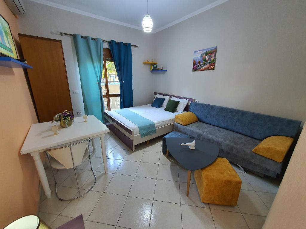 een woonkamer met een bank en een bed bij My Apartments Durres in Durrës