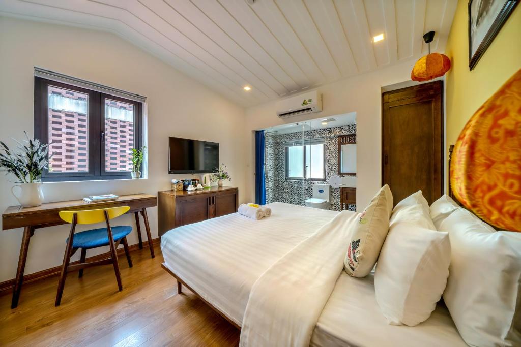 Postel nebo postele na pokoji v ubytování Son Trang Hotel Hoi An