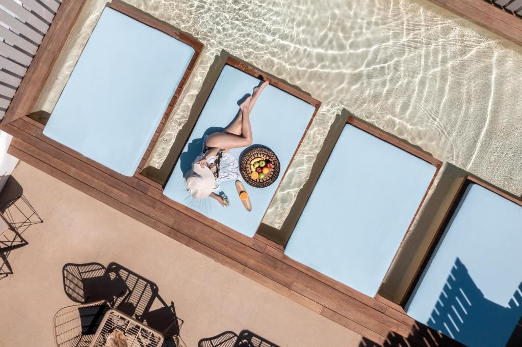 a person is doing a trick on a trampoline in front of windows at Argo Boutique Hotel in Naxos Chora