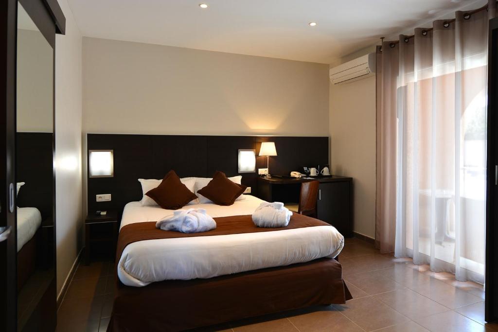 Postel nebo postele na pokoji v ubytování Hotel U Ricordu & Spa