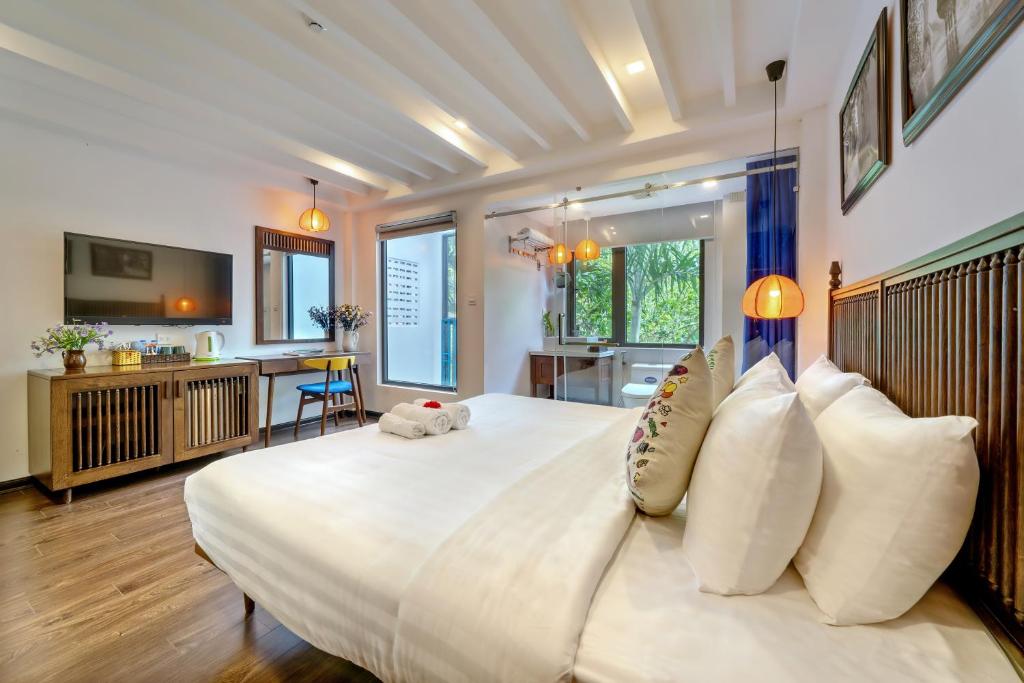 Postel nebo postele na pokoji v ubytování Son Trang Hotel Hoi An