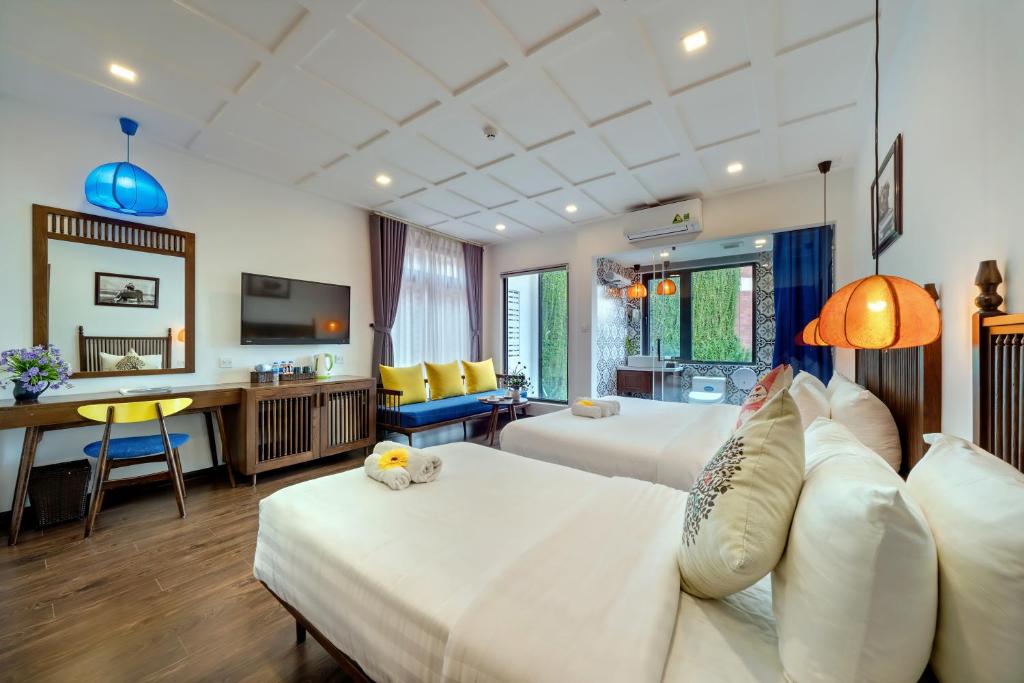 Postel nebo postele na pokoji v ubytování Son Trang Hotel Hoi An