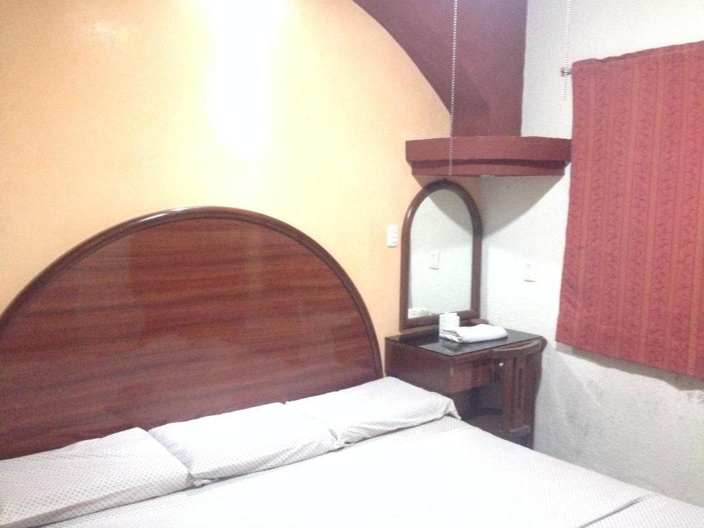 Postel nebo postele na pokoji v ubytování Hotel Xalapa