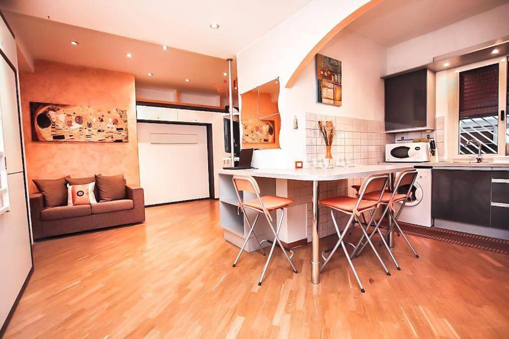 a kitchen with a table and chairs in a room at PETITE HOME IN ROME in Rome