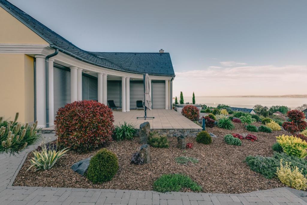 a garden in front of a house at Villa Georgina in Badacsonytomaj