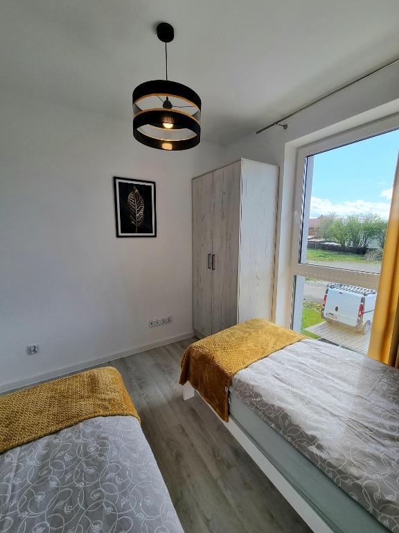 Posteľ alebo postele v izbe v ubytovaní Domek pod świerkami - "Apartamenty świerkowe"