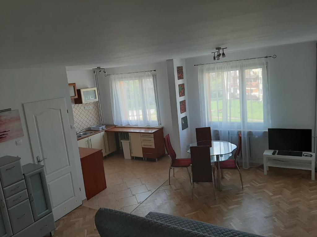 a living room with a table and a dining room at Apartament Bella in Bolesławiec