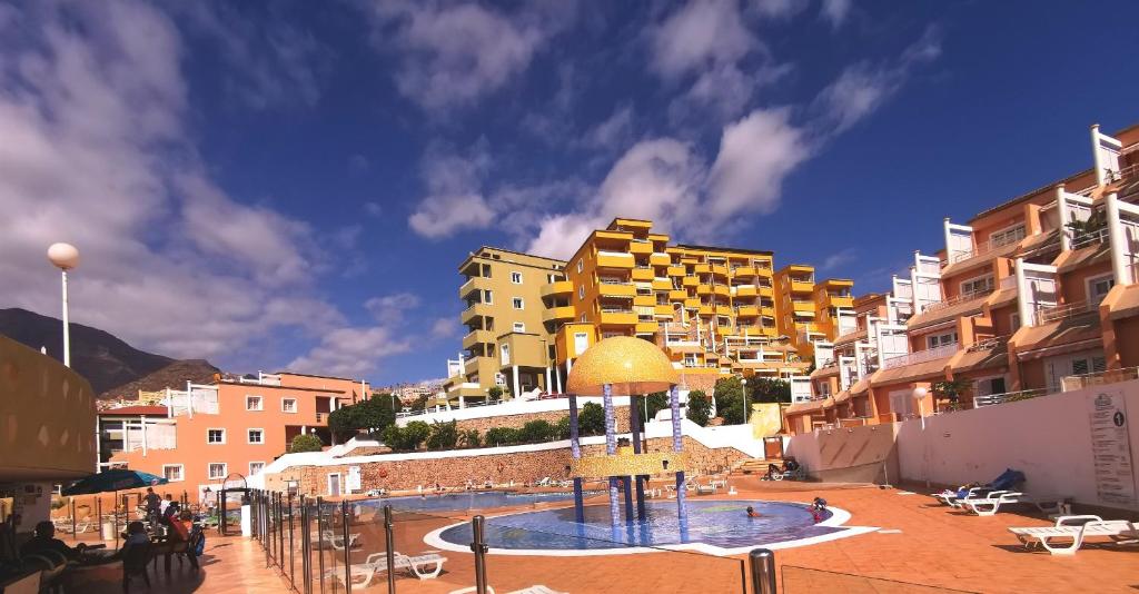 a group of buildings and a swimming pool in a city at Apartment Orlando Torviscas Bajo in Adeje