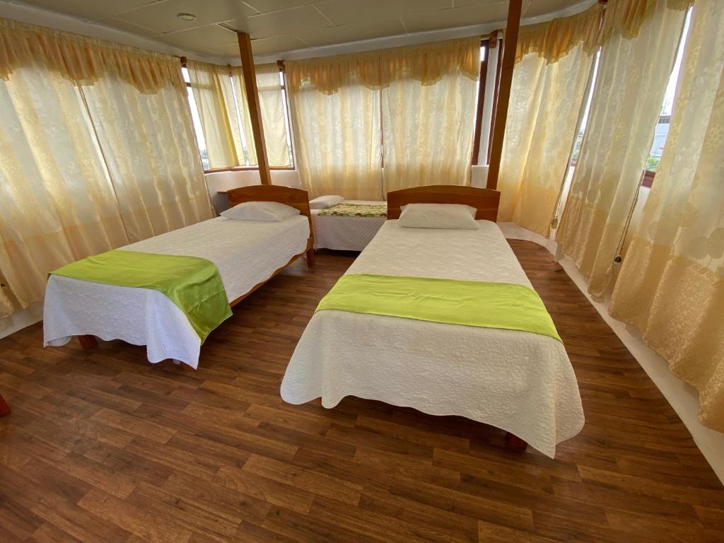 Postel nebo postele na pokoji v ubytování Hostal Casa Edén