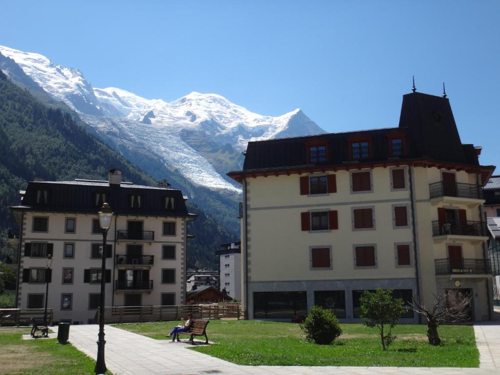 a couple of buildings in front of a mountain at 4-star apartments in Chamonix centre with free private parking in Chamonix