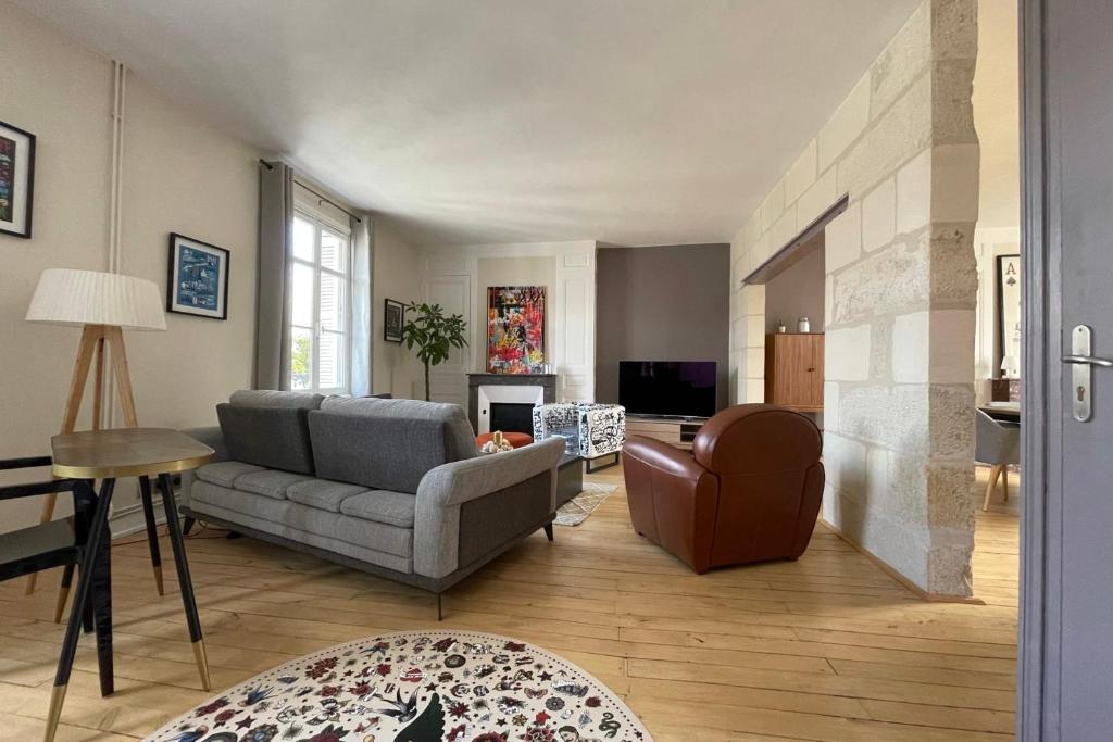 a living room with a couch and a chair at Superb duplex near the Halles de Tours in Tours