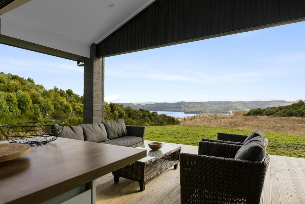 a patio with a couch and chairs and a table at Raptor's Haven - Kinloch Holiday Home in Kinloch