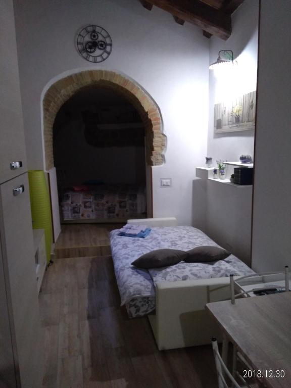 Postel nebo postele na pokoji v ubytování Le Vecchie Mura Apartment
