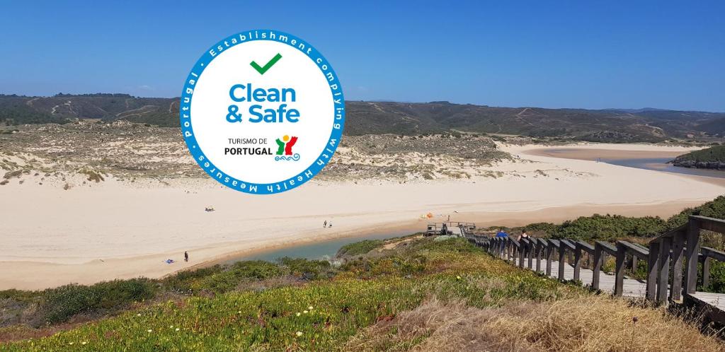 a sign for clean and safe at a beach at Monte Clérigo - Aljezur - Apartamento T2 in Aljezur