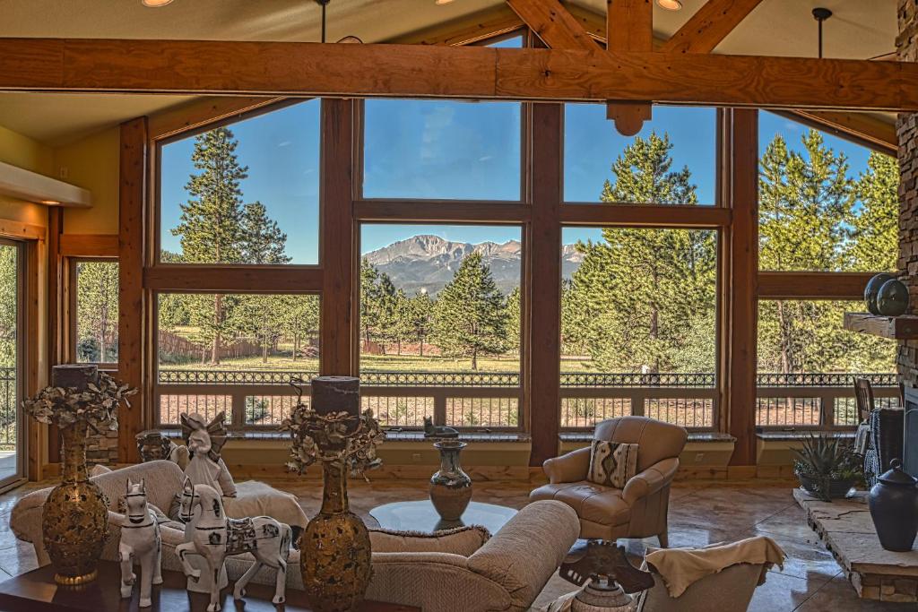 a living room with a large window with a mountain view at Rampart Range Resort in Woodland Park