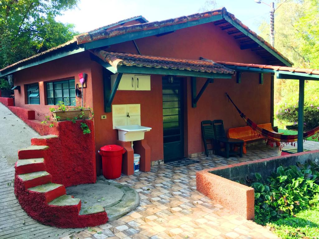 a small red house with a stairs leading to it at um pedaço do paraíso in São Roque