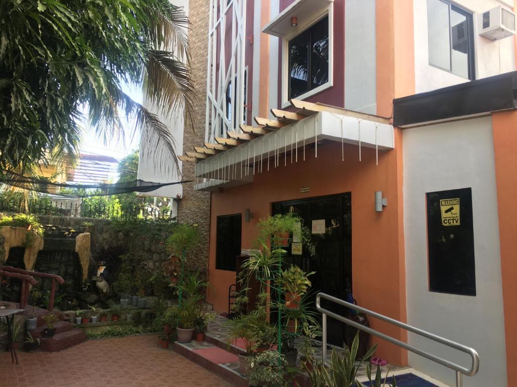 a building with a courtyard with plants in front of it at Isteraha Haven Inn in Zamboanga