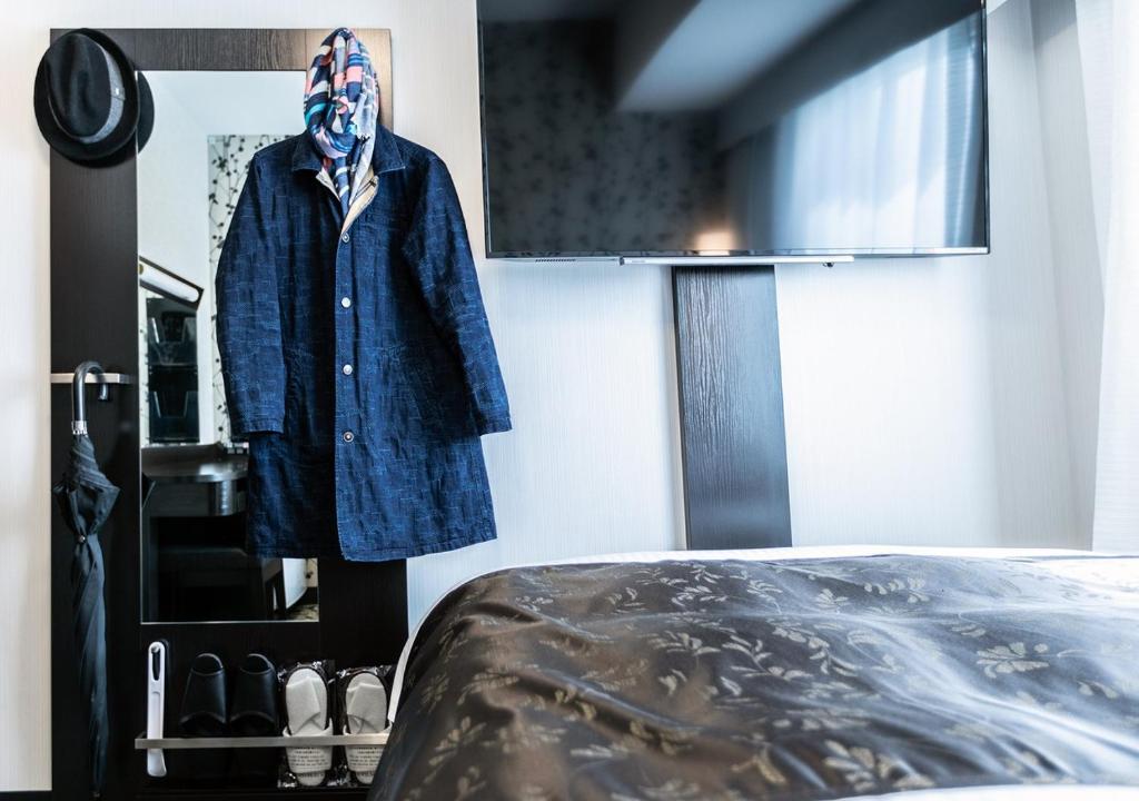 Postel nebo postele na pokoji v ubytování APA Hotel Nagoya Ekimae