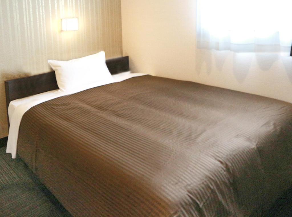 Postel nebo postele na pokoji v ubytování Hotel Trend JR Uji Ekimae