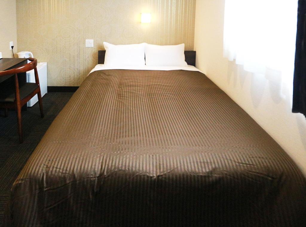 Postel nebo postele na pokoji v ubytování Hotel Trend JR Uji Ekimae