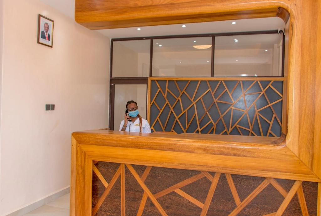 a child is sitting in a room with a window at Hotel Comster Mtwapa in Mtwapa