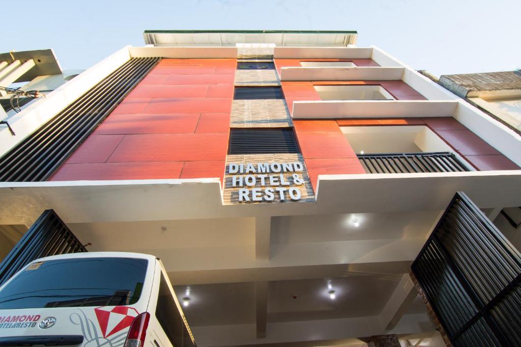 a building with a sign on the side of it at Diamond Hotel And Resto in Catarman