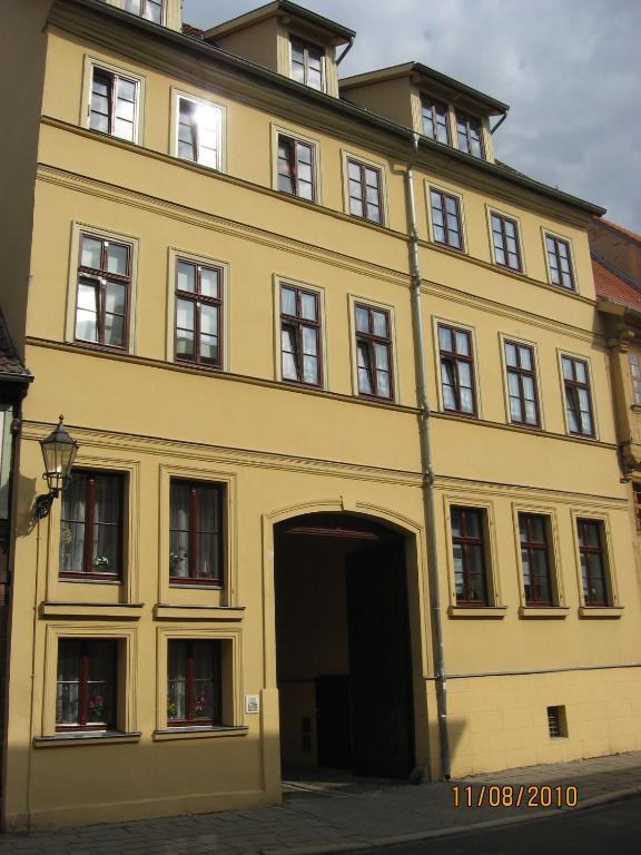 a large yellow building with a large doorway at Ferienwohnung Neuer Weg 15 in Quedlinburg