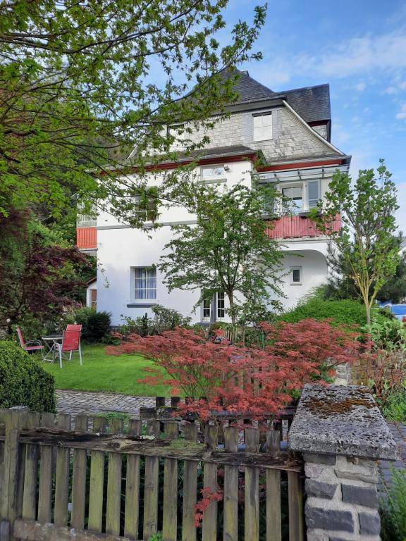 una casa bianca con una recinzione di fronte di Ferienwohnungen-In-Bacharach a Bacharach