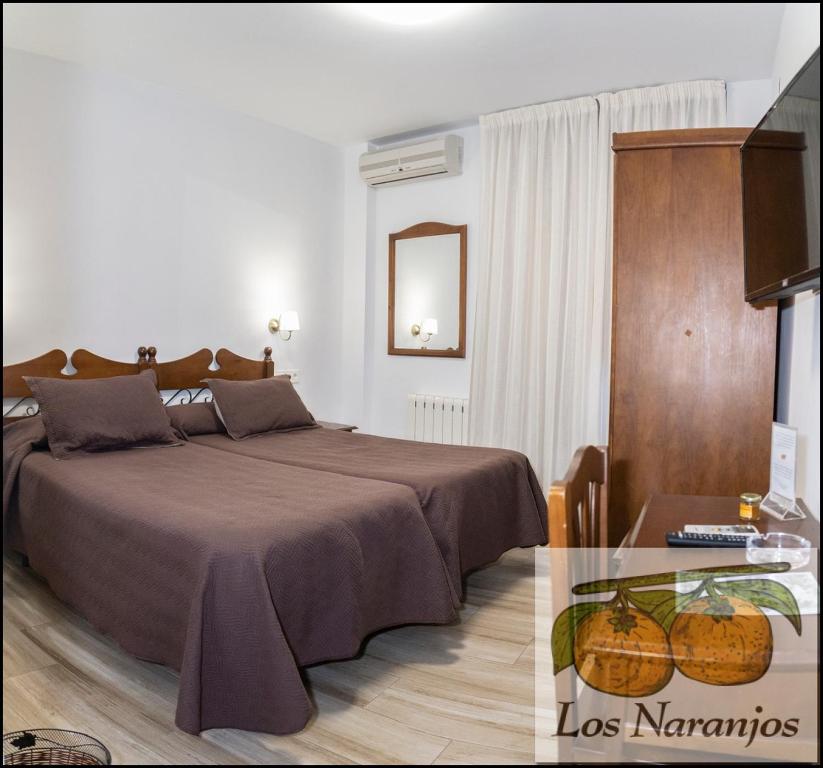Posteľ alebo postele v izbe v ubytovaní Hostal y Apartamento Rural Los Naranjos