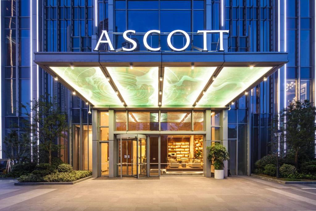 un negozio di fronte a un edificio asot di notte di Ascott Central Wuxi a Wuxi