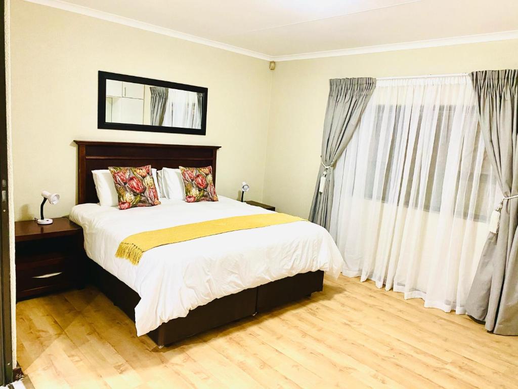 a bedroom with a large bed and a window at C&C HOTEL VIBES Randpark Ridge JHB 14 Units Available in Boskruin