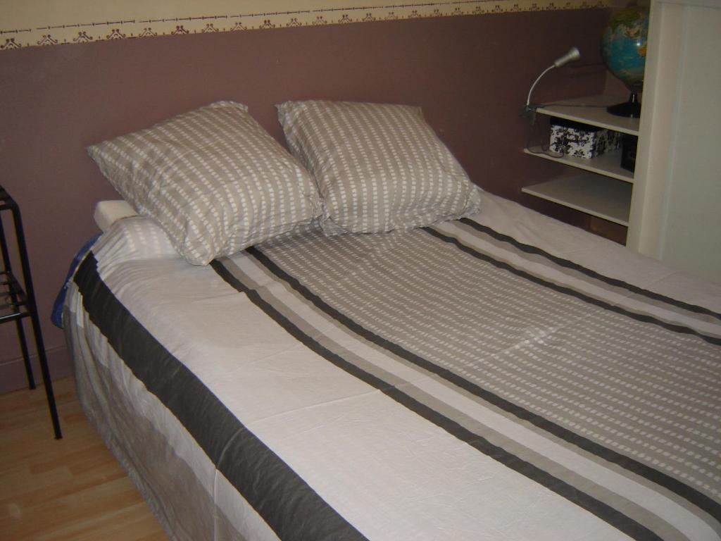 a bed with two pillows on top of it at les vignes d&#39;Ygrande in Ygrande