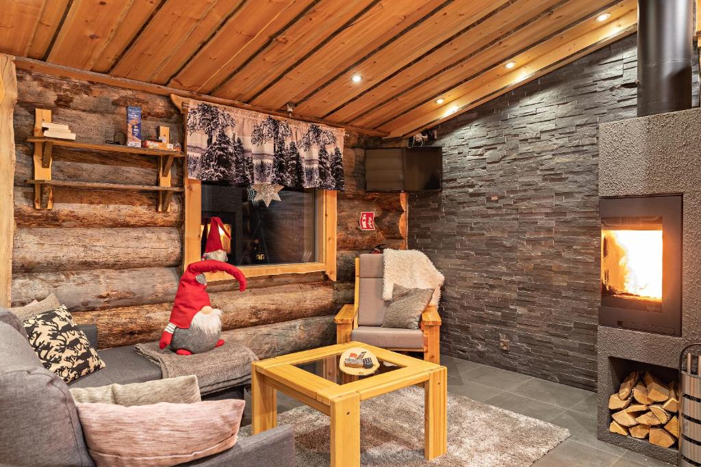 a living room with a santa claus sitting in a fireplace at Polar Aurora Cabins in Saariselka