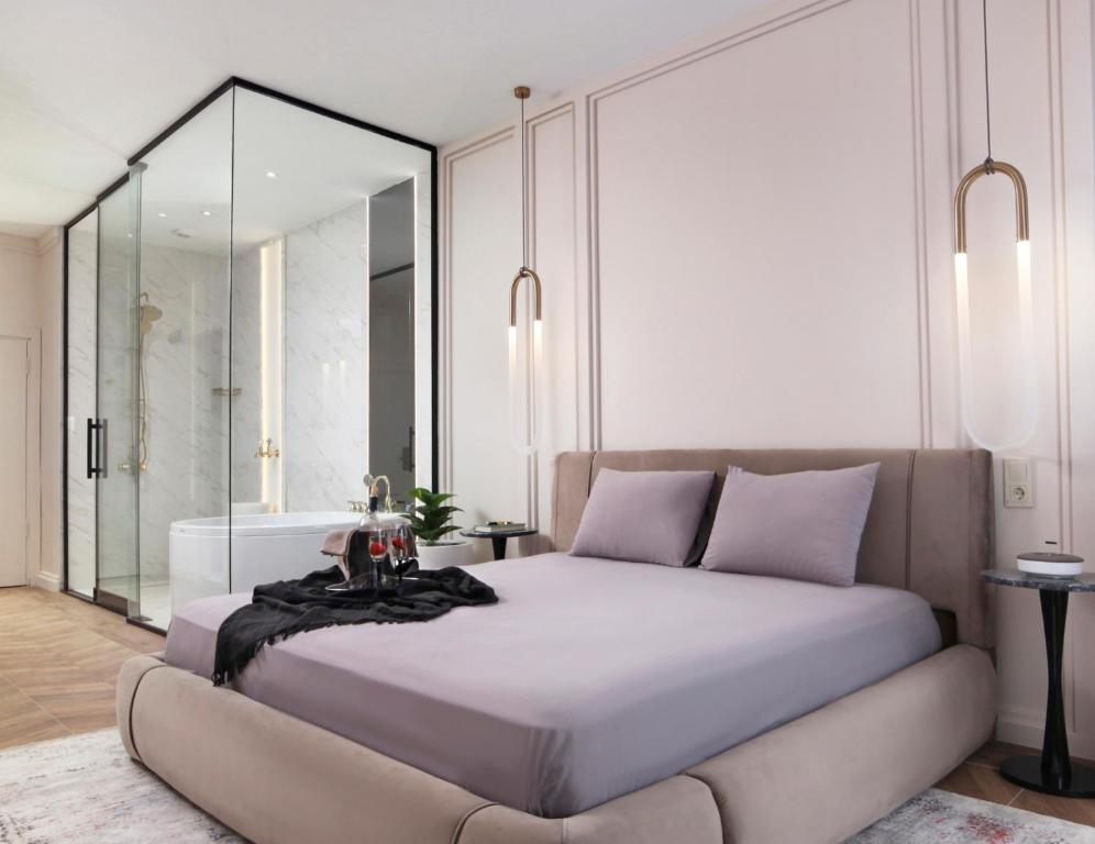 a bedroom with a large bed and a large mirror at Walton Gardens Pera in Istanbul