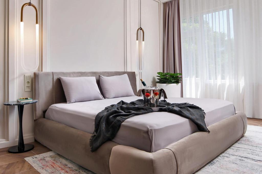 a bedroom with a bed with a black blanket on it at Walton Gardens Pera in Istanbul