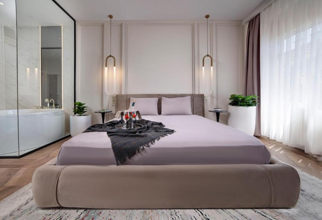 a bedroom with a large bed and a bath tub at Walton Gardens Pera in Istanbul