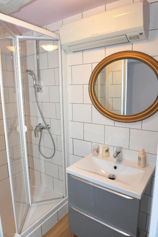 a bathroom with a sink and a shower at Chambres d&#39;hôtes Chez Caroline in Colmar