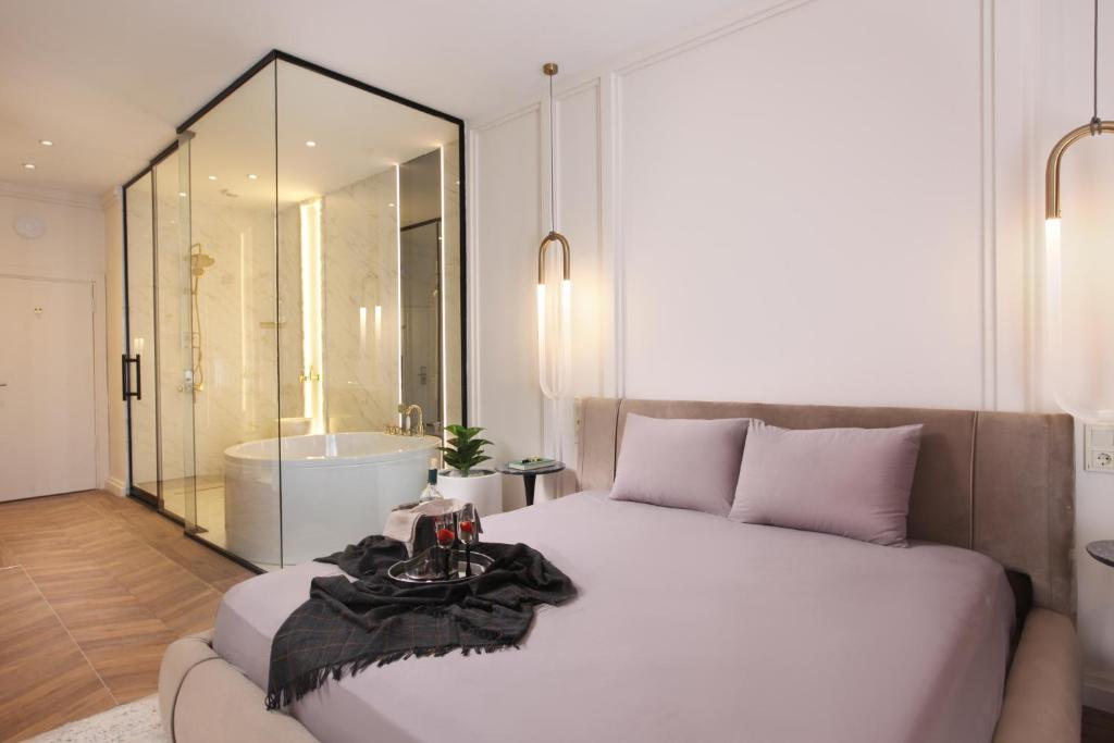 a bedroom with a large bed and a bath tub at Walton Gardens Pera in Istanbul
