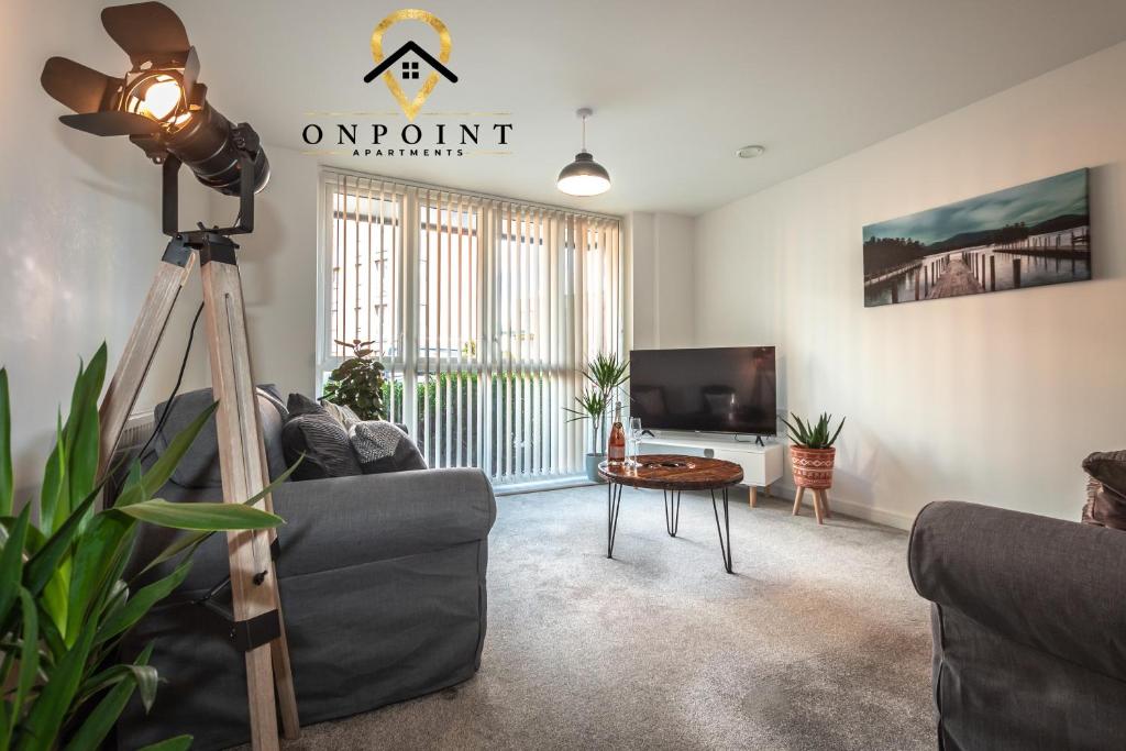 a living room with a couch and a camera at OnPoint- AMAZING Apartment Perfect for Business/Work/Leisure! in Reading