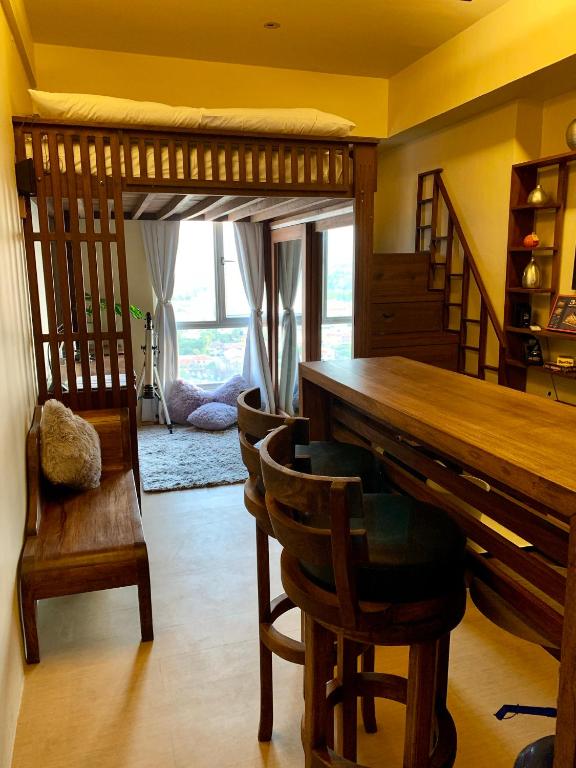 a dining room with a wooden table and chairs at Penthouse Condo Studio Unit CENTRIO TOWER w/ Stove in Cagayan de Oro
