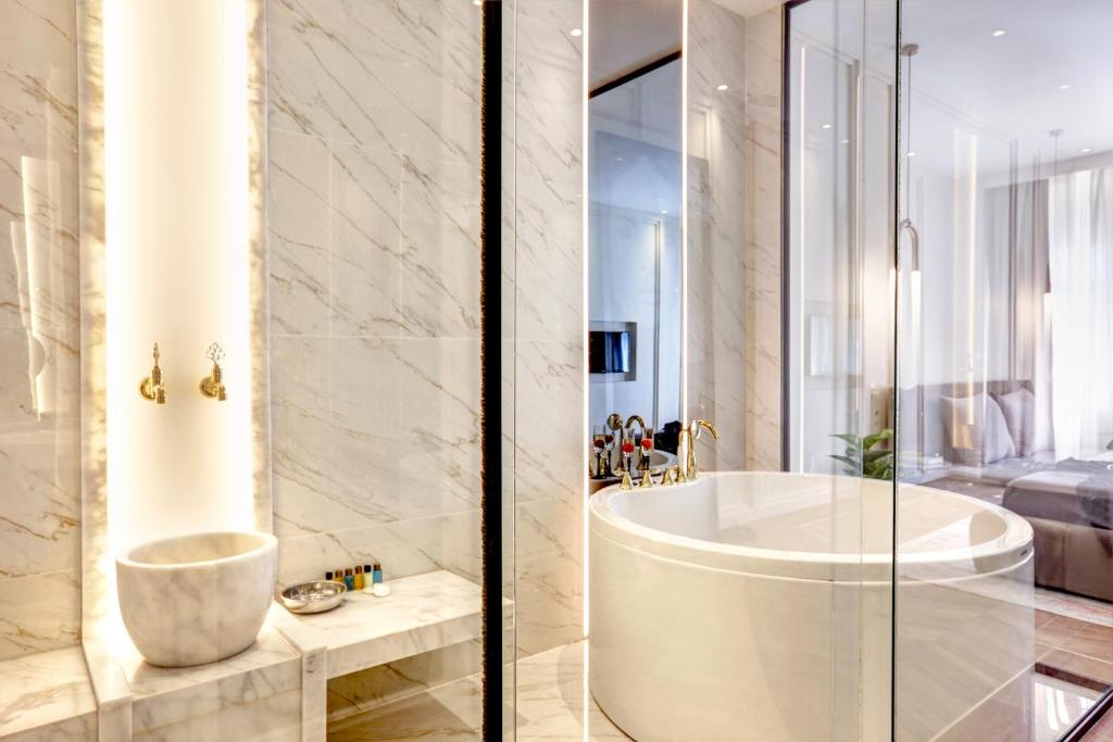 a bathroom with a bath tub and a sink at Walton Gardens Pera in Istanbul