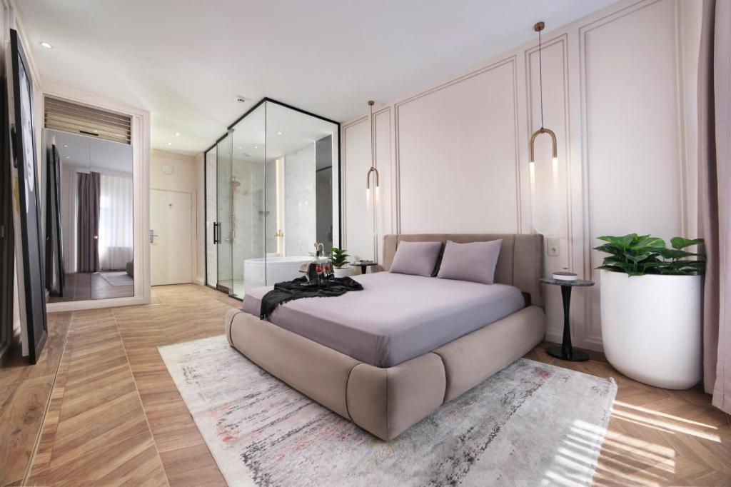 a bedroom with a large bed and a large mirror at Walton Gardens Pera in Istanbul
