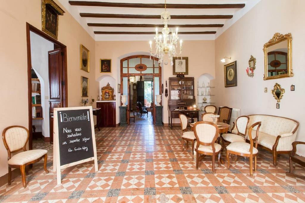 a room with a table and chairs and a chalkboard at Villa Charly Casa señorial XVII Historical Villa in Macastre