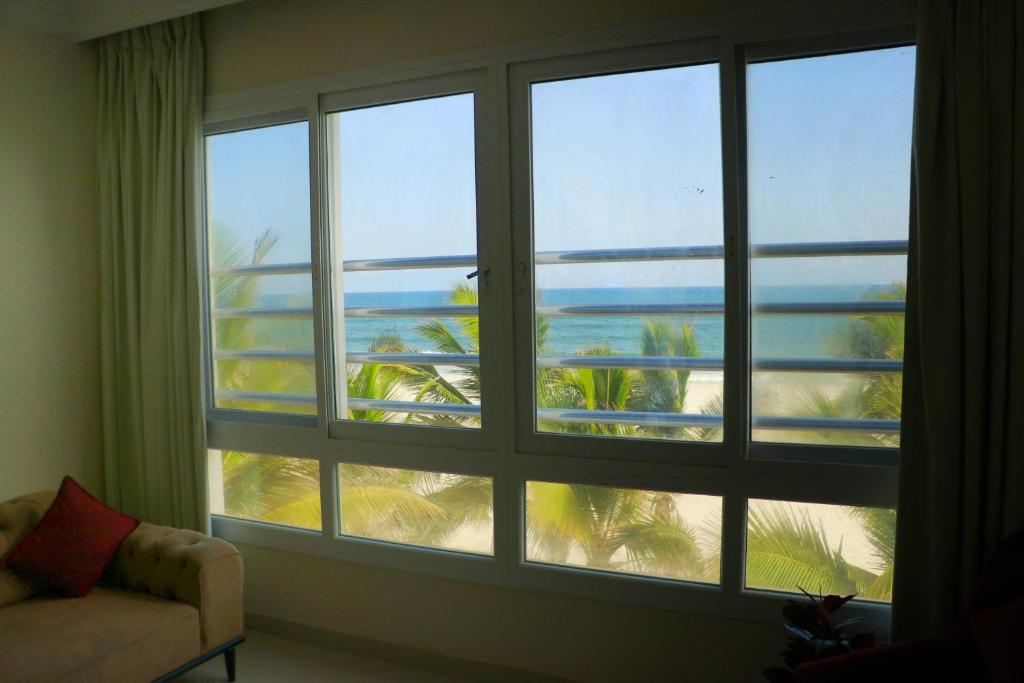 a room with a large window with a view of the beach at ALmansor furnished apartment 3 in Salalah