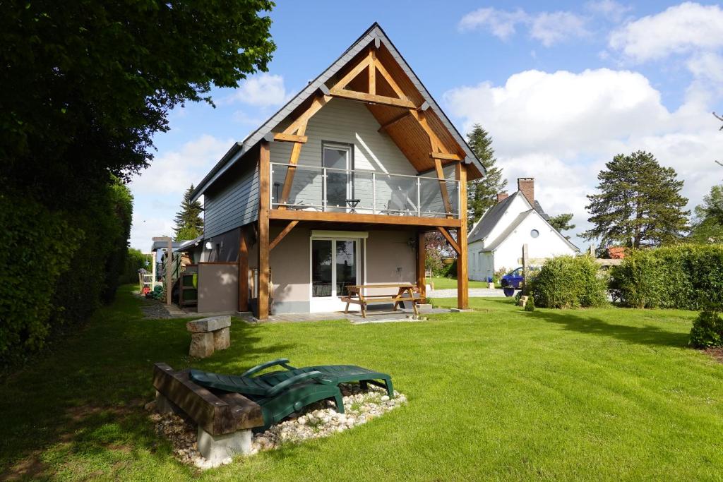 a large house with a gambrel roof on a yard at LE CLOS BRAYON in Saint-Honoré