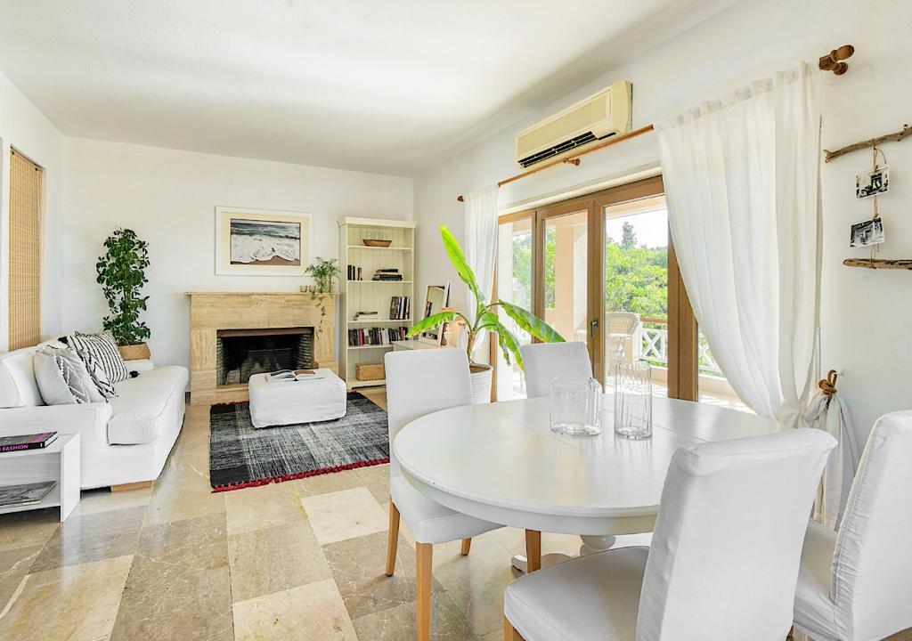 a living room with a white table and chairs at Sanidiamonds in Sani Beach