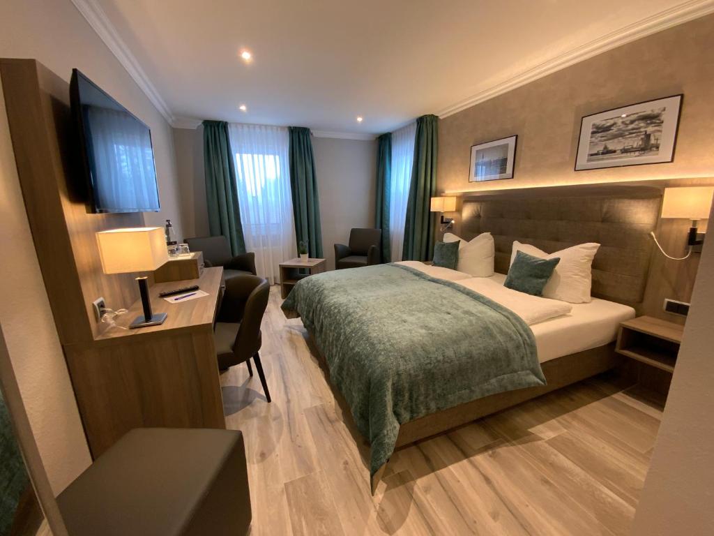 Postel nebo postele na pokoji v ubytování Mertinkus Nordseehotel