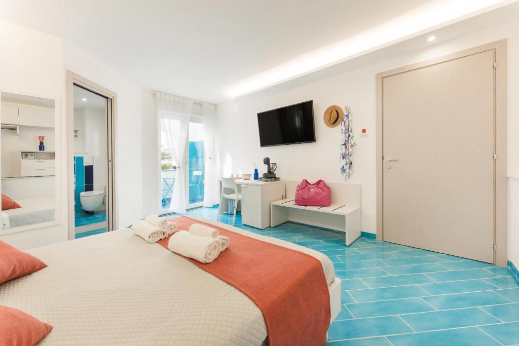 a hotel room with a bed and a bathroom at Corallo Residence in Procida