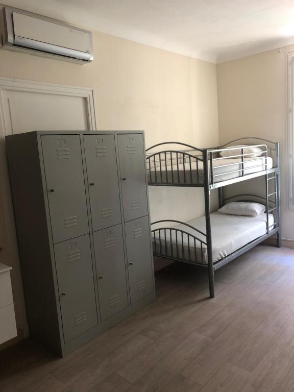 a room with two bunk beds and lockers at La Promenade House in Nice