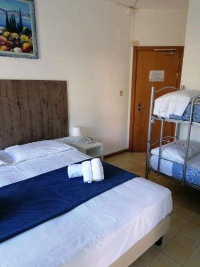 Postel nebo postele na pokoji v ubytování Hotel Danieli